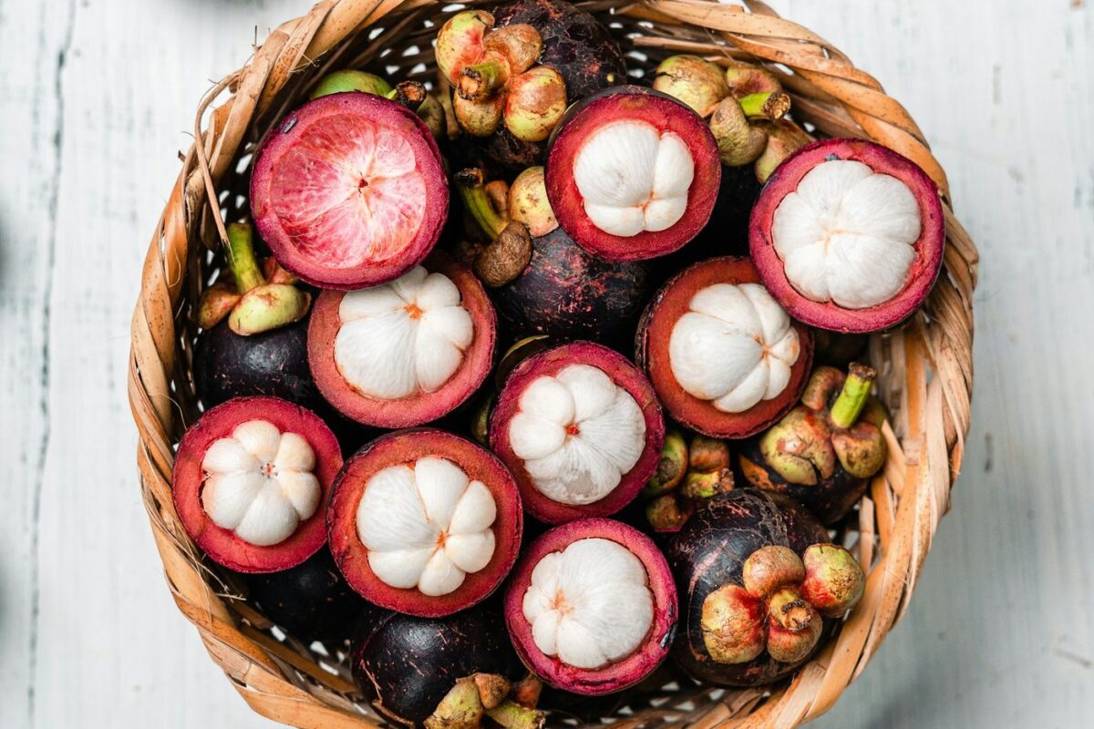 Opened mangosteens in a woven basket