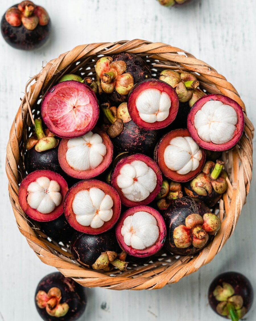 Opened mangosteens in a woven basket
